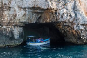luzzu boat in a cave in blue grotto malta
