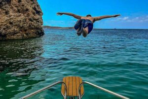 Guests enjoying a jumping platform during a private Malta boat trip, perfect for watersports, jet ski rides, and cruise liner excursions.