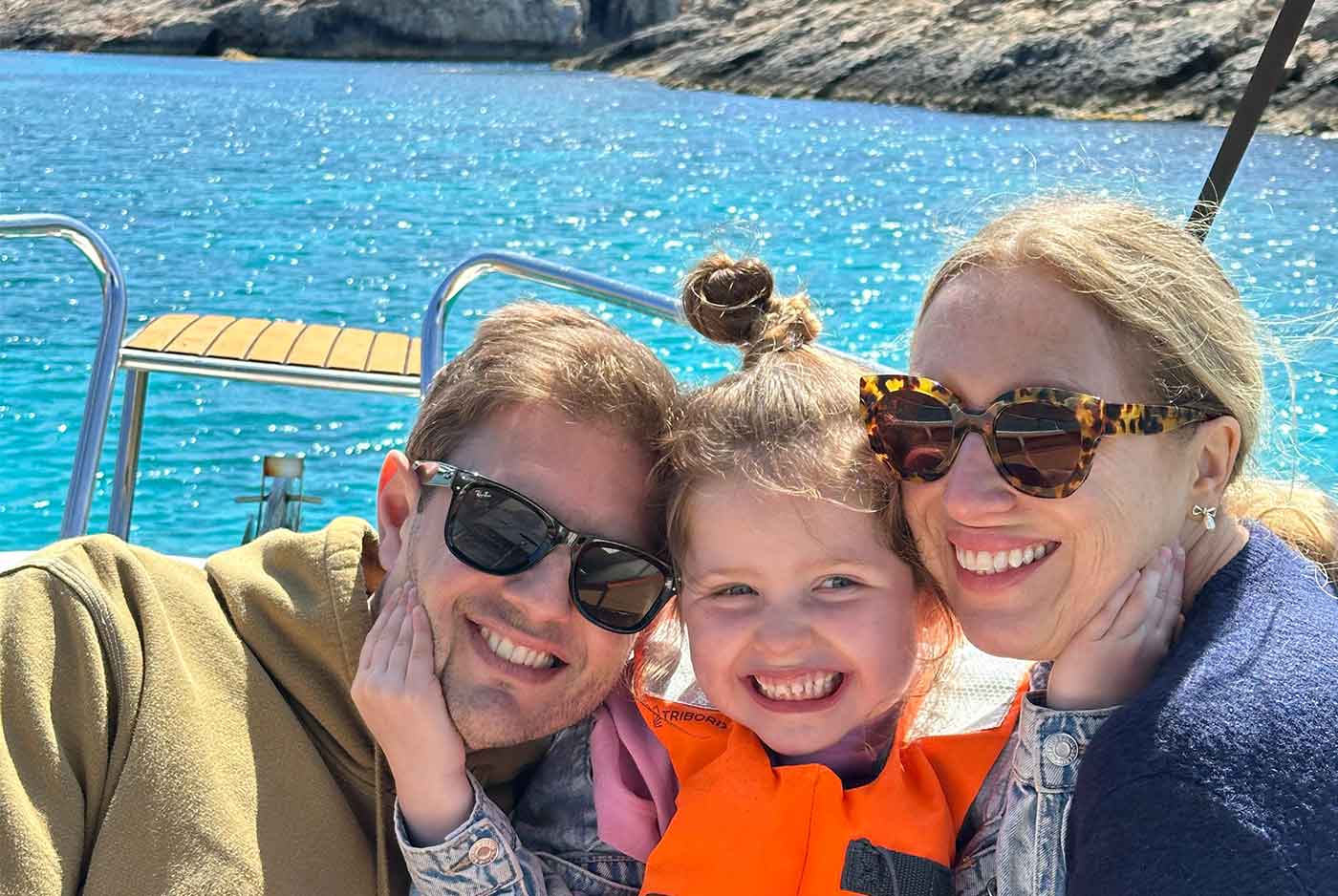 Family enjoying a private boat tour in Malta, spending time together on calm blue waters near Comino Island.