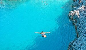 Cliff diving at Crystal Lagoon Comino with clear blue water, dramatic cliffs, and private boat access away from crowds in Malta