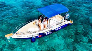 Private boat trip in Malta with guests enjoying calm blue waters, open sea views, and an exclusive experience on the Mediterranean.