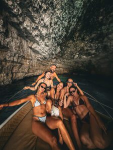 Group of ladies celebrating birthday hen party at Santa Marija Caves Comino during private boat tour Malta in crystal clear blue water