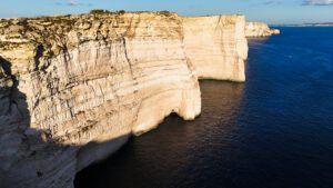 Sanap and Ta’ Ċenċ sea caves on Gozo’s coast, featuring dramatic cliffs, deep blue water, and natural rock formations.