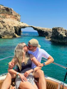 Couple kissing near Elephant Rock formation in Comino, Malta during a private boat tour