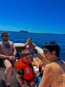 Family with kids on board private boat tour Malta enjoying Comino Blue Lagoon swimming and relaxing together in clear blue water