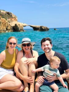 Family with kids on board private boat Malta enjoying Comino Blue Lagoon swimming, relaxing together in safe clear blue water experience