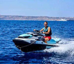 Fast jet ski riding in Malta with high speed action on clear blue sea