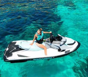 Lady enjoying jet ski rental in Malta on crystal clear blue sea near Comino
